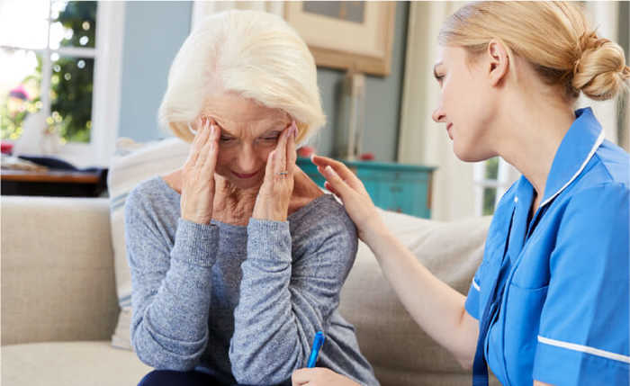 Side effects, image showing a nurse and a woman holding her head